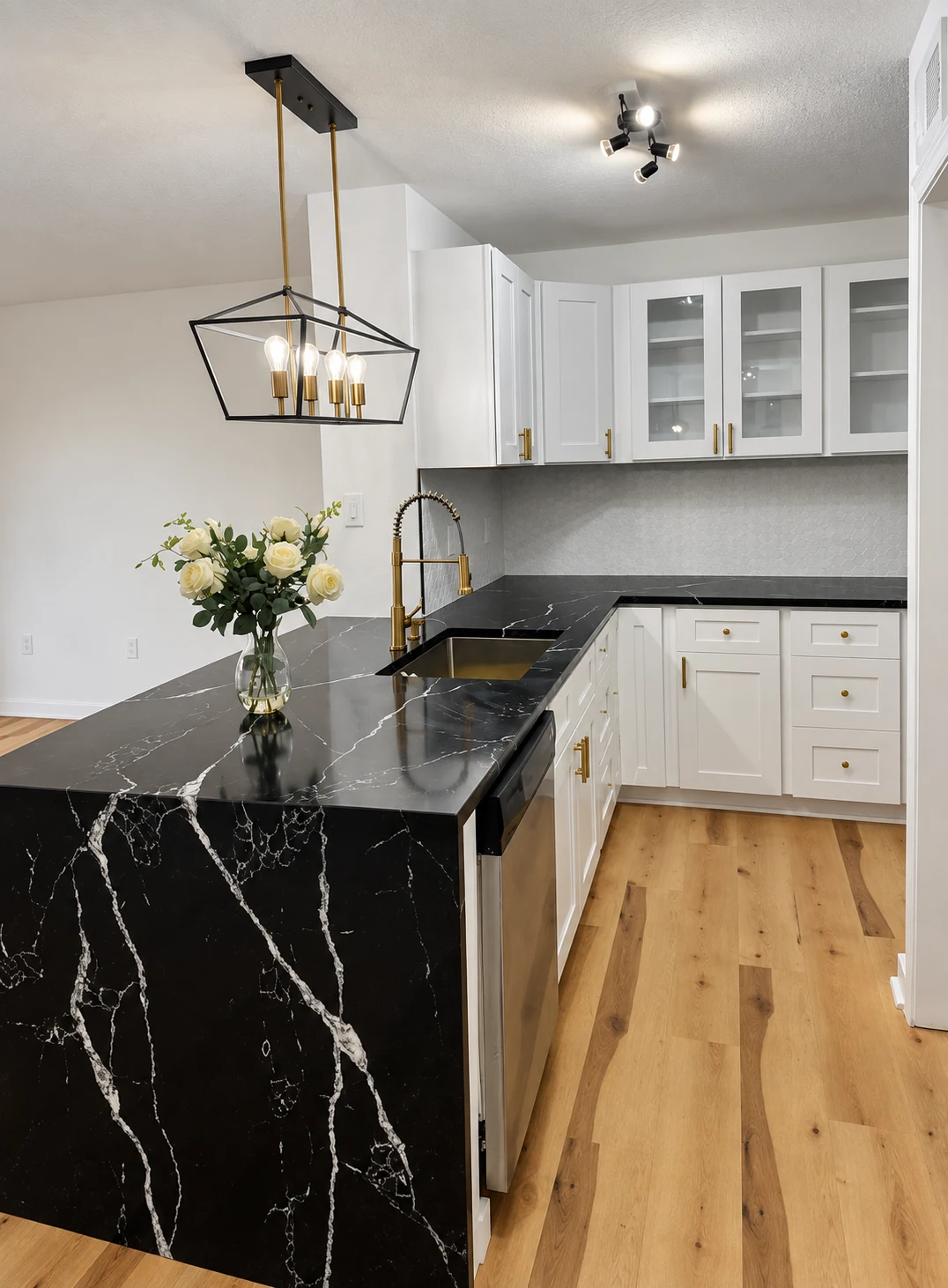 White cabinets and glass-front uppers alongside dark, veined countertops
